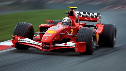 Red Formula 1 car on racing circuit track in motion.