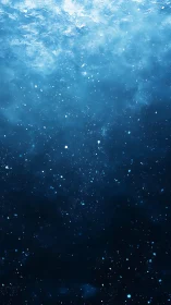 Deep blue underwater particles drift through fading light