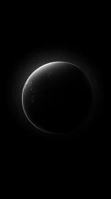 Luminous crescent planet emerging from deep cosmic shadow.