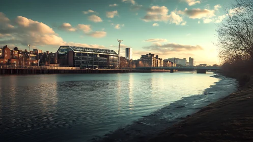 Sunlit urban riverscape with modern glass warehouse architecture.