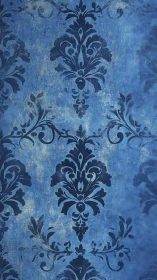 Midnight blue damask flourishes on softly clouded wall.