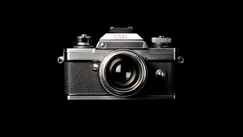 Front view classic 35mm SLR film camera on black background