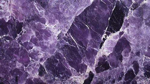 Purple crystalline stone surface displays fractured veined microstructure