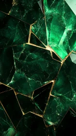 Emerald crystal shards with gold geometric fracture lines.