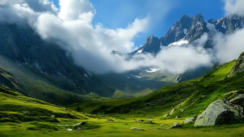 Green alpine valley under dramatic clouds and peaks.