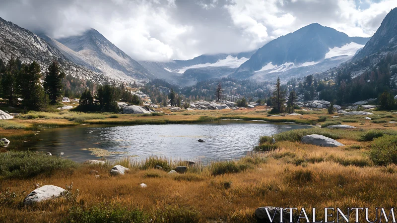 Alpine lake below rugged granite peaks in early autumn.