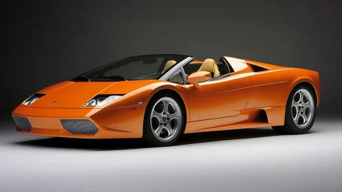 Orange Italian supercar roadster under studio lighting.