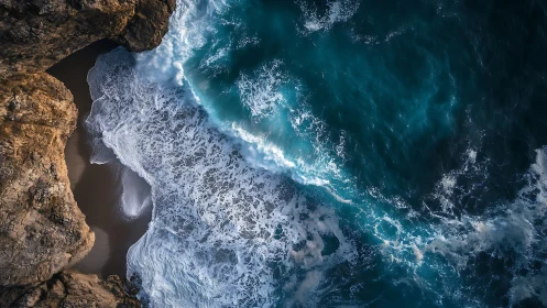 Waves crash against rugged cliffs in a dramatic aerial seascape.