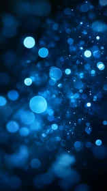 Defocused blue bokeh particles form a luminous abstract field