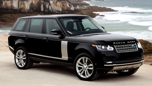 Black luxury SUV parked on coastal dirt overlook