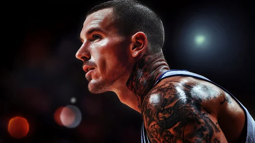 Tattooed basketball player under dramatic arena lights.