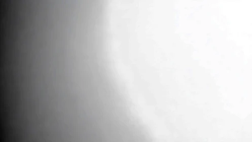 Monochrome gradient surface with soft lateral light transition.