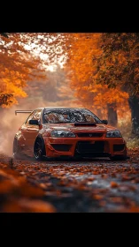 Modified orange sports car accelerates through autumn forest lane