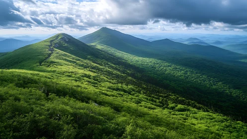 Ridge-line mountain panorama under dramatic stratified storm clouds
