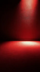 Red textured wall and floor under focused overhead lighting