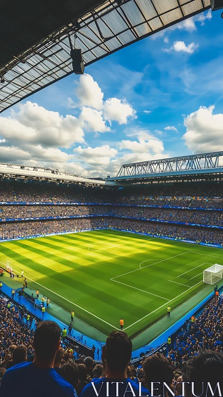 Packed football stadium under bright blue sky on matchday.