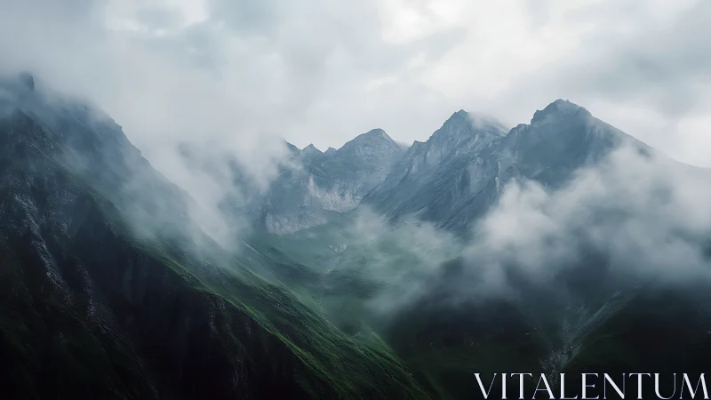 Fog-covered mountain ridge with steep rocky green slopes.
