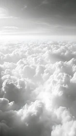 High-altitude cumulus cloudscape in monochrome aerial perspective.