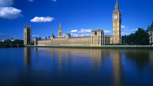 Riverside palace and clocktower bask in cobalt London skies.