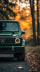 Autumn-lit front profile of emerald Mercedes G-Class SUV.