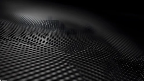 Abstract metallic perforated surface with dark gradient lighting.