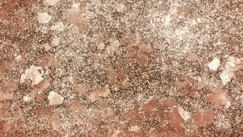 Copper-toned granular surface shows dense glitter distribution