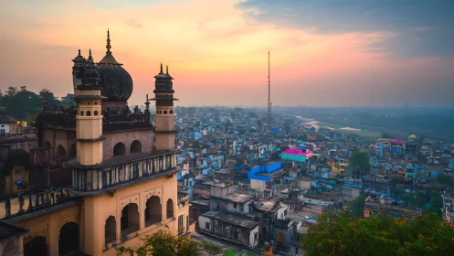 Historic domed palace above dense Indian cityscape at dusk.
