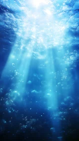 Sunbeams piercing deep blue ocean with drifting bubbles.