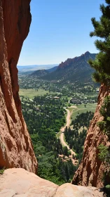 Red rock gap overlooks winding road and forested valley