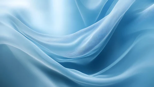 Flowing Light Blue Silk Fabric Abstract Background in Soft Focus.