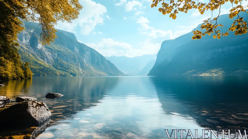 Glacial lake basin with mirrored alpine ridges under clear sky.