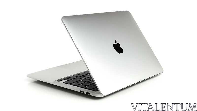 Sleek silver laptop leans open, promising quiet creative speed