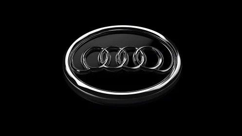 Audi logo in 3D metallic style on glossy black background.
