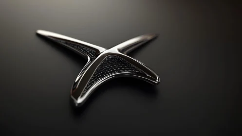 Sleek metallic X-shaped emblem on dark background, modern style.