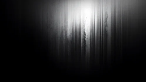 Vertical whispers of light unraveling through grayscale hush.