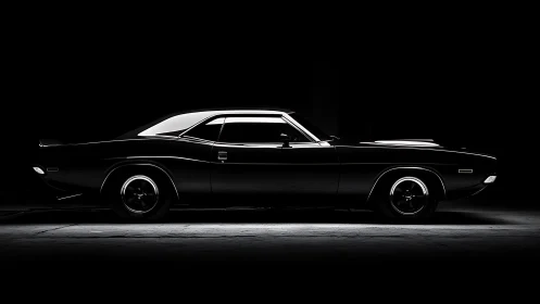 Sleek black muscle car emerges from dramatic studio shadows