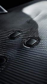 Carbon fiber surface with integrated glossy control buttons.