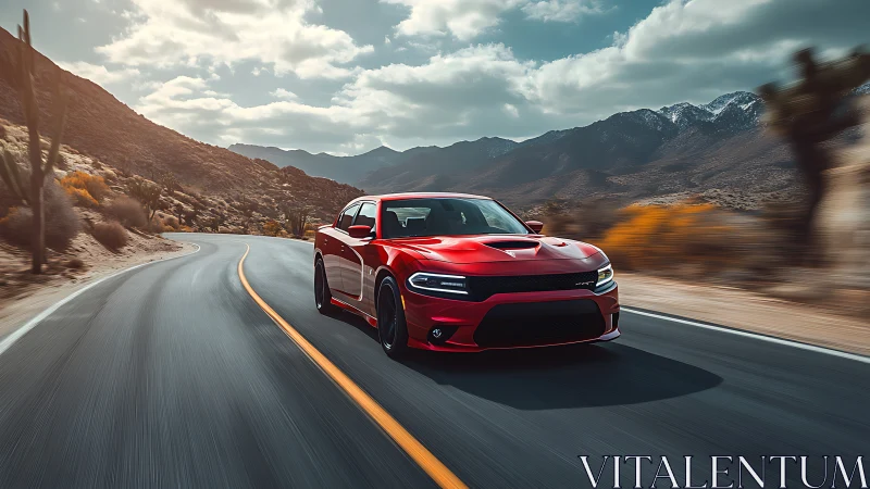 Crimson muscle car streaks through sunlit desert canyon road.