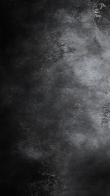 Dark concrete surface shows worn, textured grayscale pattern