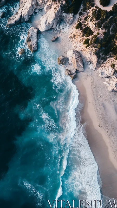 Aerial view captures turquoise surf meeting rocky coast