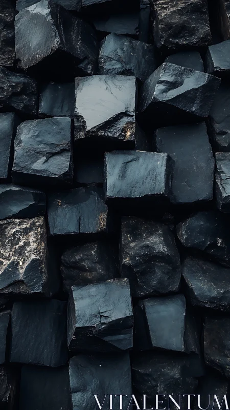 Stacked dark stone cubes with rough glossy textures.