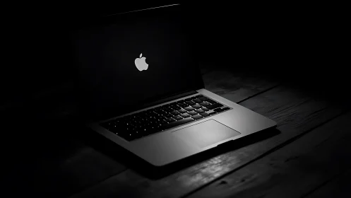 Cozy silver laptop glowing softly in a quiet dark room.