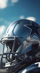 Shining silver football helmet under a clear blue sky.