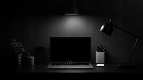 Minimalist dark desk setup with laptop and desk lamps.
