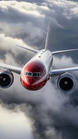 Crimson airliner gliding confidently through soft white clouds.