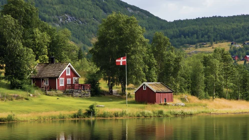 Red lakeside cottage and barn rest in peaceful Nordic valley.