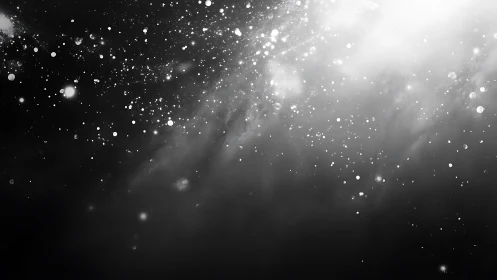 Starry monochrome dust cloud drifts through deep darkness.