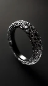 Textured black metal ring rendered against dark background