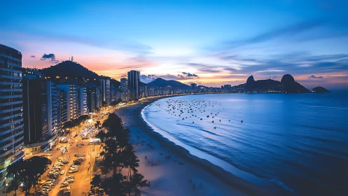 Twilight coastal skyline with illuminated avenue and curving urban bay