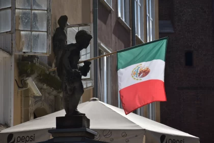 Gdańsk, Poland: Statue of a Stone Boy With a Mexican Flag